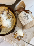 Skillet cookie with ice cream and a Dr. Peter's label on burlap